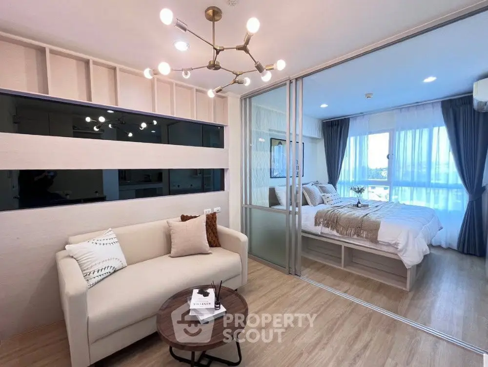 Modern living room with elegant lighting and cozy bedroom view