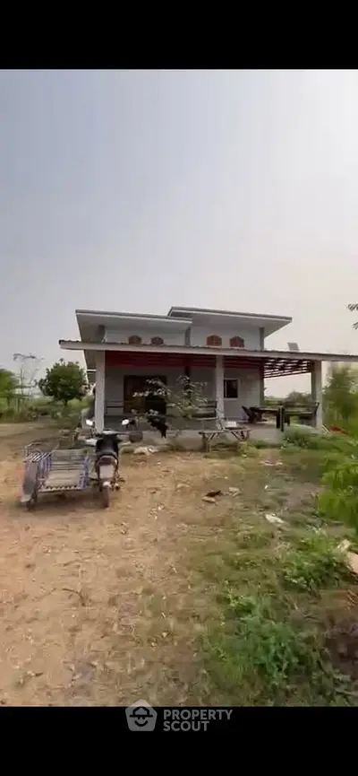 Charming countryside house with spacious yard and rustic appeal, perfect for tranquil living.