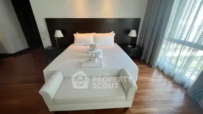Luxurious bedroom with elegant decor and natural light, featuring a cozy bed and stylish furniture.