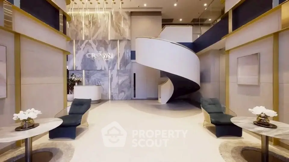 Luxurious modern lobby with elegant spiral staircase and stylish seating area.