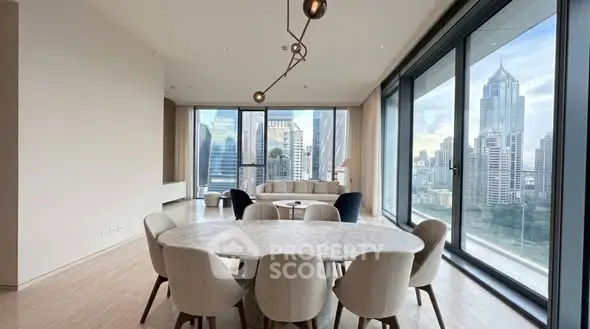 Luxurious dining area with panoramic city views and modern furnishings in a high-rise apartment.