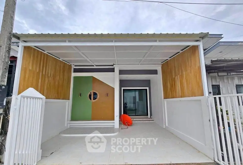 Modern minimalist house exterior with unique geometric door design and spacious entrance.