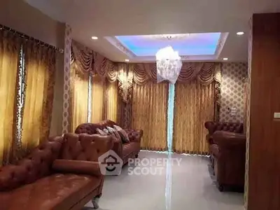Luxurious living room with elegant drapes and plush leather sofas