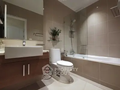 Modern bathroom with sleek fixtures and bathtub in contemporary apartment.