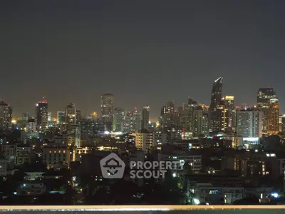 Stunning city skyline view at night with illuminated skyscrapers and urban landscape.