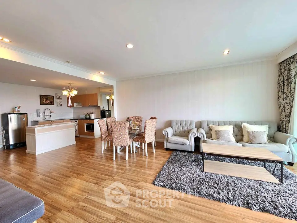 Spacious open-plan living room with modern kitchen and elegant decor