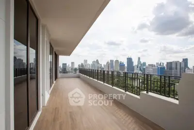 Spacious balcony with stunning city skyline view, perfect for relaxation and entertainment.