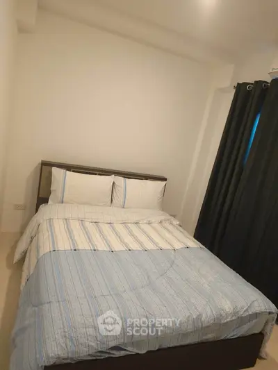 Cozy bedroom with modern decor and comfortable bedding in a stylish apartment.