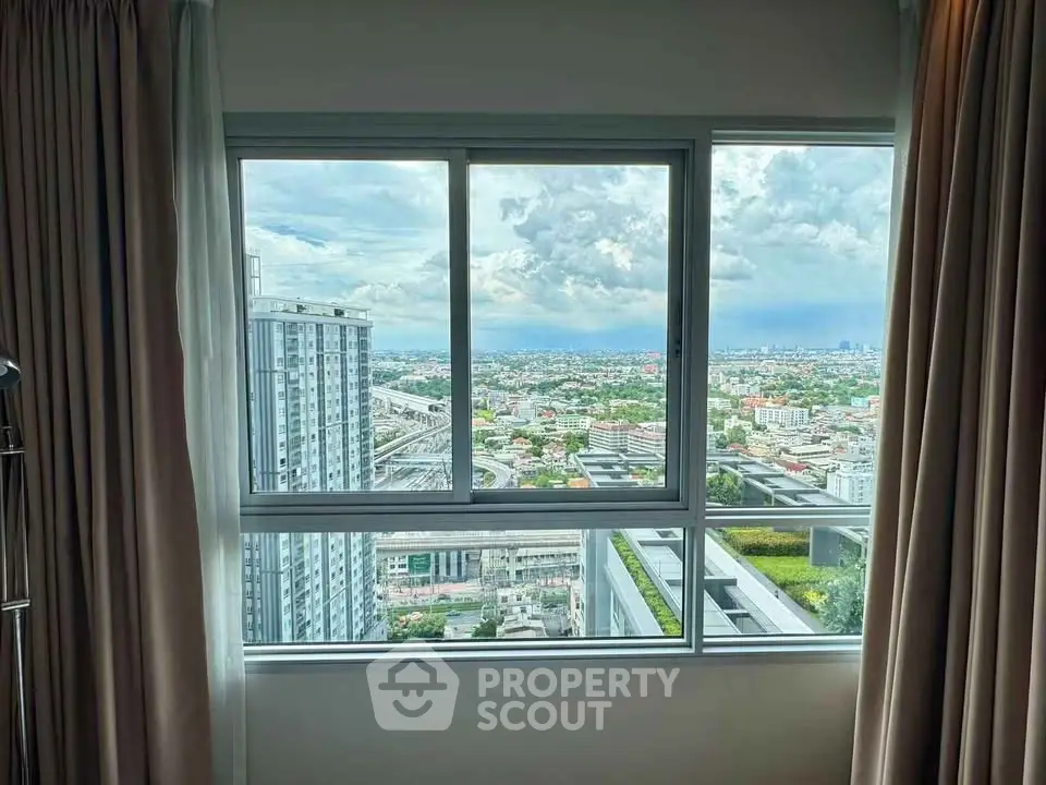 Stunning high-rise apartment view with expansive cityscape and lush greenery.