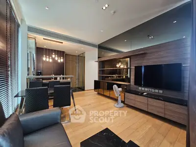 Modern living room with sleek design, open kitchen layout, and stylish lighting fixtures.