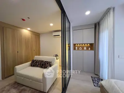 Modern living room with stylish decor and sliding glass doors in a cozy apartment.
