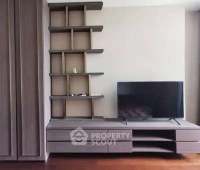Modern living room with sleek TV stand and built-in shelving, perfect for stylish urban living.