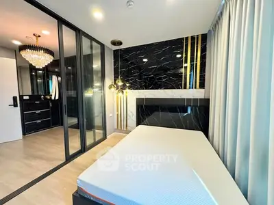 Luxurious modern bedroom with elegant chandelier and mirrored wardrobe