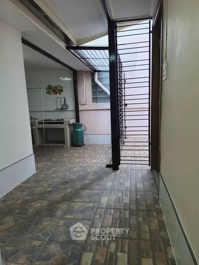 Spacious open kitchen area with tiled flooring and gas stove setup