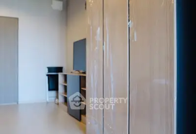 Modern living room with sleek wooden furniture and flat-screen TV, perfect for contemporary living.