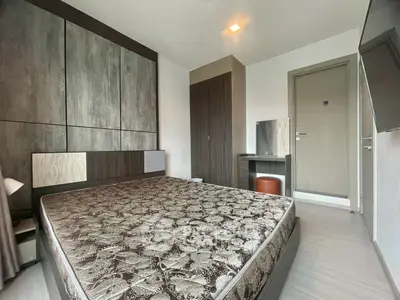 Modern bedroom with stylish decor and large bed in a contemporary apartment.