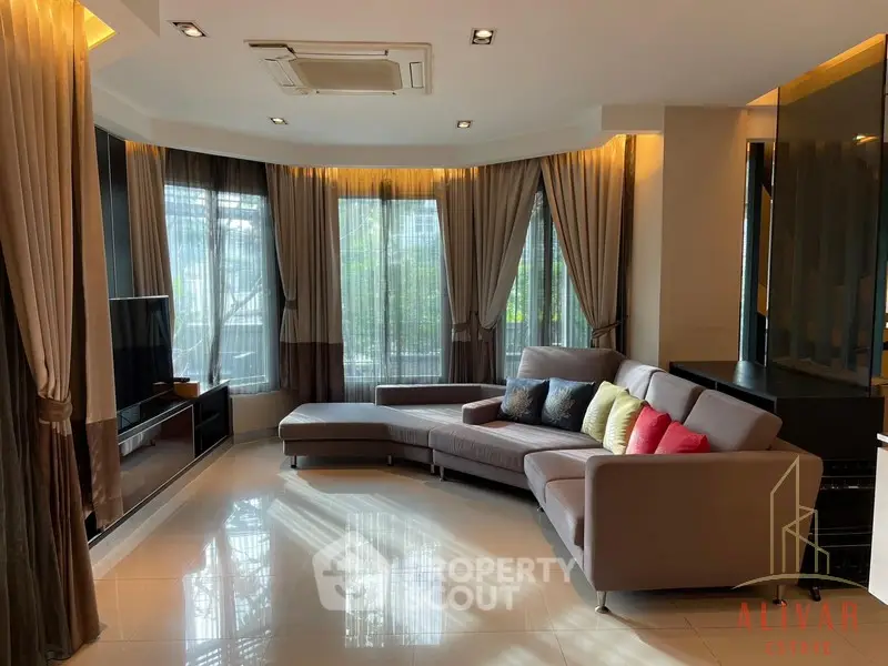 Luxurious spacious living room with polished tile flooring, elegant drapery, and modern furniture, perfect for upscale urban living.