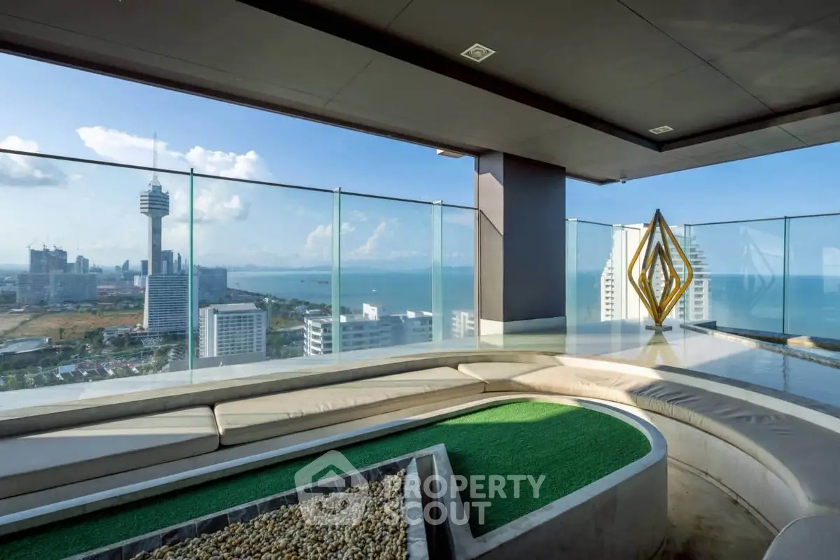 Luxurious rooftop terrace with stunning ocean view and modern seating area