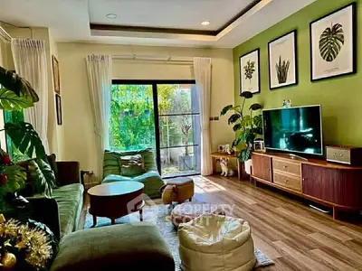 Stylish living room with green accents, large window, and modern furniture for a cozy ambiance.