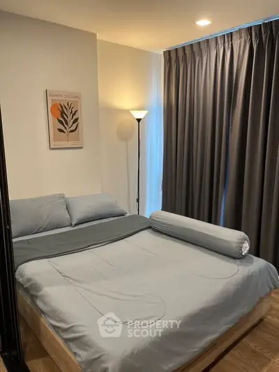 Cozy bedroom with modern decor and soft lighting, featuring a comfortable bed and elegant curtains.