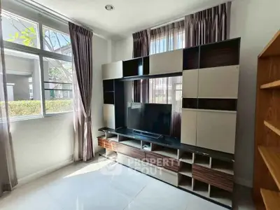 Modern living room with stylish entertainment center and natural light
