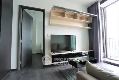 Modern living room with sleek TV setup and balcony view