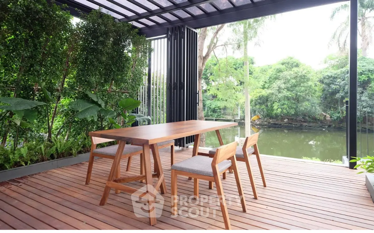 Stunning garden view from a modern patio with elegant wooden furniture.
