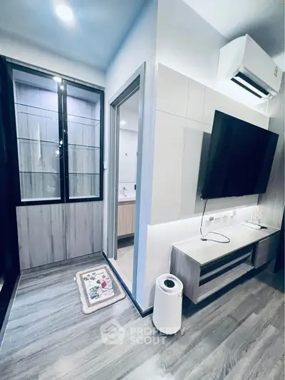 Modern living room with sleek design, featuring air conditioning and wall-mounted TV for ultimate comfort.