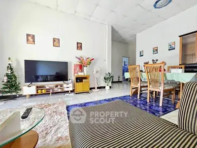 Spacious living room with modern decor and dining area, perfect for family gatherings.