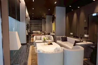 Luxurious modern living room with elegant furniture and ambient lighting, perfect for sophisticated gatherings.