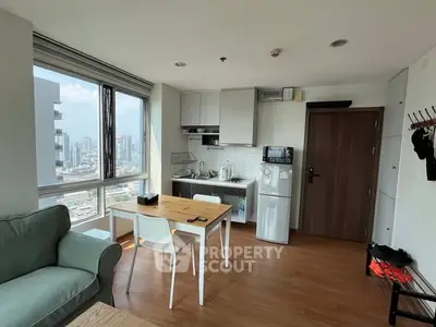 Modern apartment interior with city view, featuring a cozy living area and compact kitchen.
