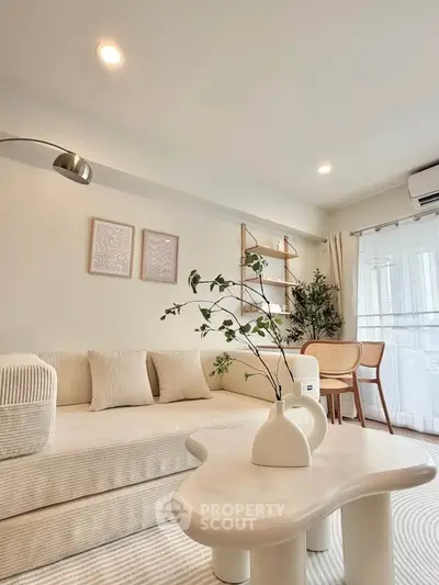 Stylish modern living room with cozy sofa and elegant decor, perfect for relaxation and entertaining.