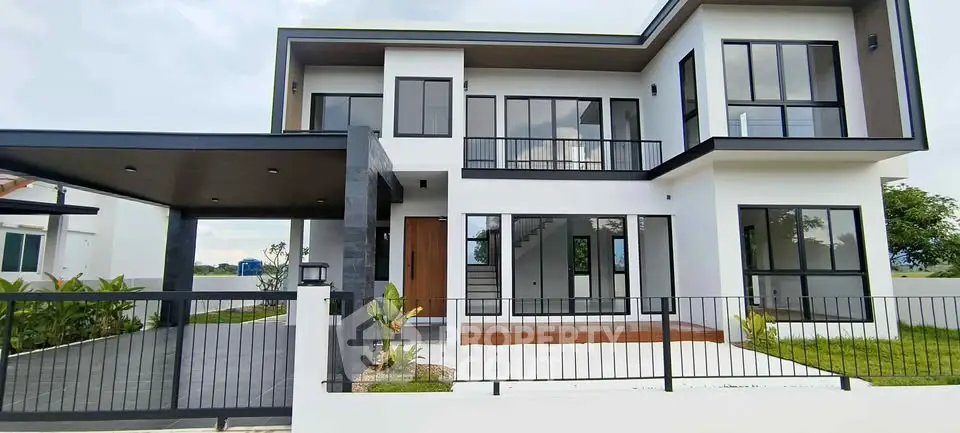 Modern two-story house with sleek design and large windows