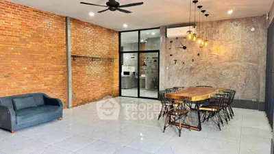 Spacious modern living room with brick wall and stylish dining area