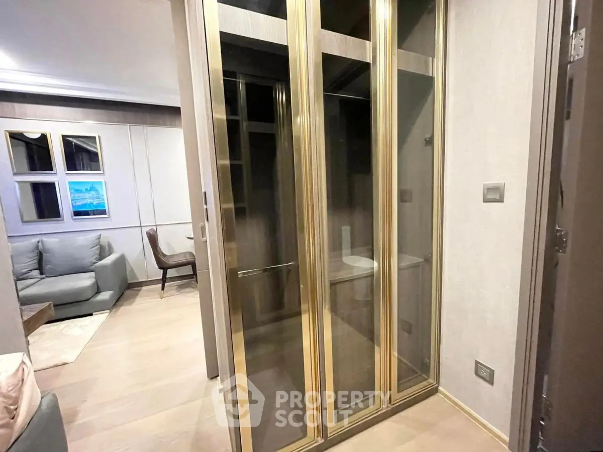 Elegant modern living space with glass storage and cozy seating area.