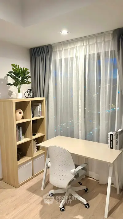 Modern study room with sleek desk, ergonomic chair, and stylish shelving unit by a large window.