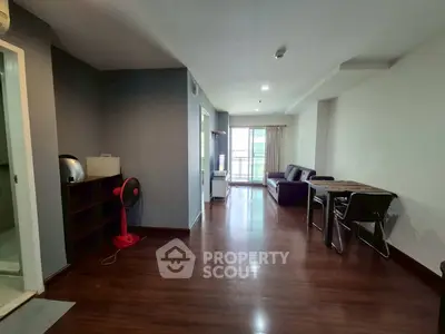 Spacious living room with modern furniture and balcony access in a stylish apartment.