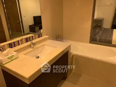Modern bathroom with elegant vanity and bathtub in a stylish apartment.