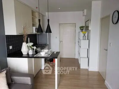 Modern kitchen with sleek design and open layout, featuring stylish pendant lights and contemporary decor.