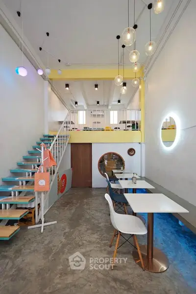 Modern loft-style interior with unique lighting and open mezzanine