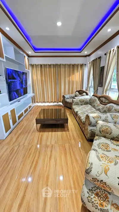 Luxurious living room with elegant furniture and modern lighting, perfect for relaxation and entertainment.