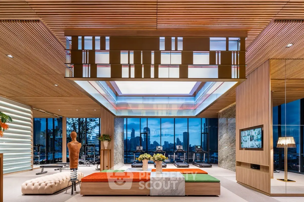 Luxurious modern living room with stunning city skyline view, elegant decor, and spacious seating area.