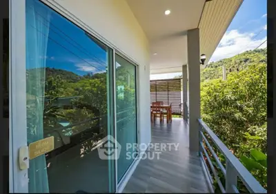 Spacious balcony with scenic mountain views and outdoor dining area, perfect for relaxation and entertaining.