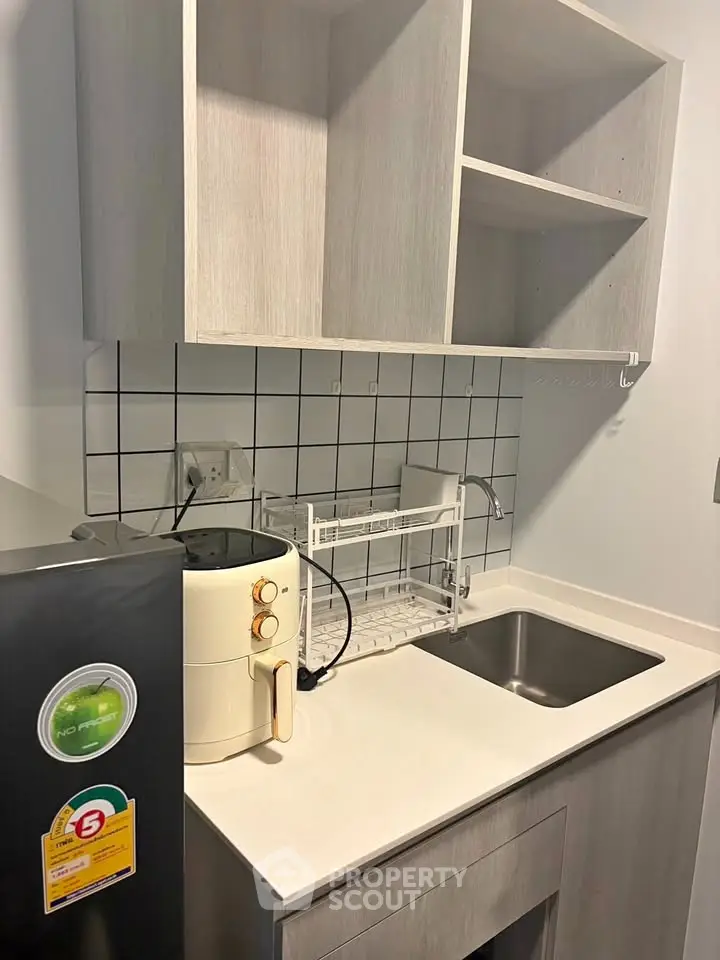 Modern kitchen with sleek cabinetry and compact appliances, perfect for urban living.