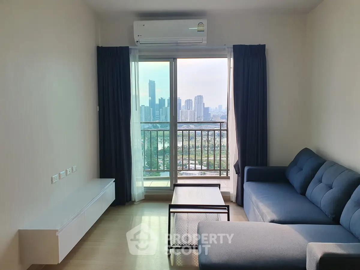 Modern living room with city view, featuring a blue sofa and large windows for natural light.