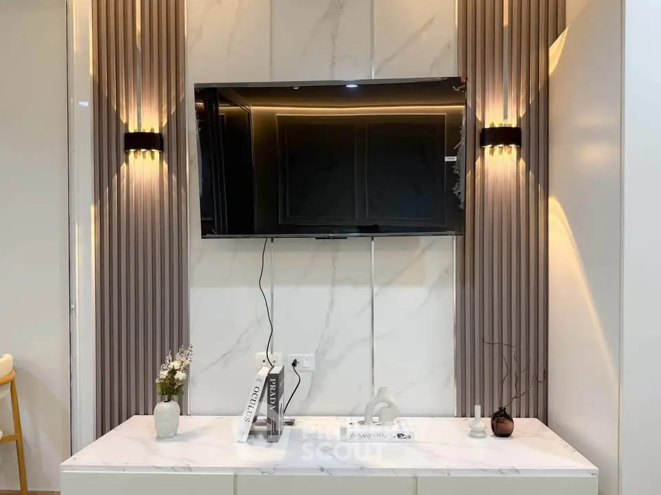 Modern living room with wall-mounted TV and elegant lighting