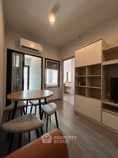 Modern living room with sleek furniture and built-in storage, perfect for urban living.