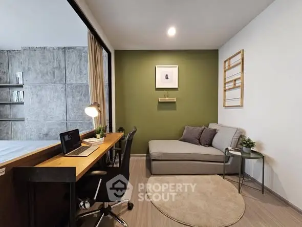 Modern study room with cozy seating and workspace in stylish apartment.