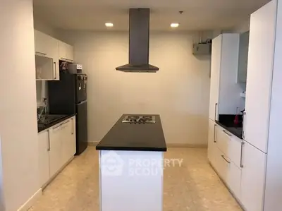 Modern kitchen with sleek black countertops and central island gas stove