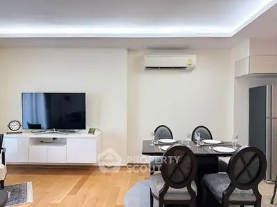 Modern living room with dining area, TV, and air conditioning unit